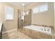 Bright main bathroom showcasing a shower, soaking tub, and large windows with plantation shutters at 169 Waterman Se St, Marietta, GA 30060