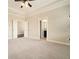 Main bedroom featuring carpeted floor and tray ceiling, connecting to the ensuite bathroom at 169 Waterman Se St, Marietta, GA 30060