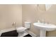 Classic powder room with a pedestal sink, round mirror, and dark hardwood flooring at 169 Waterman Se St, Marietta, GA 30060
