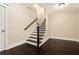 Staircase features hardwood steps, iron railings, and neutral walls with white trim at 169 Waterman Se St, Marietta, GA 30060