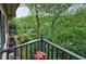 Balcony overlooking lush greenery with flower pot on the railing, creating a serene outdoor retreat at 27306 Plantation Ne Dr, Atlanta, GA 30324