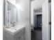 Modern bathroom featuring a sleek vanity, stylish mirror and doorway that leads to a closet at 27306 Plantation Ne Dr, Atlanta, GA 30324