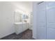 Bright bathroom featuring a white vanity with a large mirror and neutral gray carpet at 27306 Plantation Ne Dr, Atlanta, GA 30324