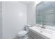 Modern bathroom featuring a sleek vanity, stylish mirror, and efficient toilet with white tile floor at 27306 Plantation Ne Dr, Atlanta, GA 30324