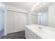 Well-lit bathroom featuring a large vanity with storage and a spacious closet at 27306 Plantation Ne Dr, Atlanta, GA 30324