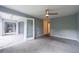 Expansive bedroom with neutral carpet, featuring ceiling fan and french doors leading to another room at 27306 Plantation Ne Dr, Atlanta, GA 30324