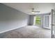 Spacious bedroom with neutral carpet, a ceiling fan, and a window providing natural light at 27306 Plantation Ne Dr, Atlanta, GA 30324