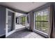 Calm bedroom with neutral tones, light-filled windows, and walk-through to sunroom/balcony at 27306 Plantation Ne Dr, Atlanta, GA 30324