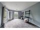 Bright bedroom with gray walls, plush carpet, and stylish ladder shelves for a modern touch at 27306 Plantation Ne Dr, Atlanta, GA 30324