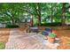 Inviting courtyard with brick pathway, benches, and colorful potted flowers at 27306 Plantation Ne Dr, Atlanta, GA 30324