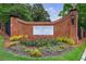 Community entrance sign with vibrant landscaping and decorative brickwork at 27306 Plantation Ne Dr, Atlanta, GA 30324