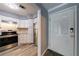 Inviting entryway view into updated kitchen with stainless steel appliances and white cabinets at 27306 Plantation Ne Dr, Atlanta, GA 30324