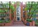 Beautiful brick condo building with an arched window and well-maintained landscaping at 27306 Plantation Ne Dr, Atlanta, GA 30324