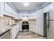 Bright kitchen with stainless steel appliances, granite countertops, and wood-look vinyl floors for modern living at 27306 Plantation Ne Dr, Atlanta, GA 30324