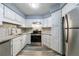 Modern kitchen features stainless steel appliances, granite countertops, and bright white cabinetry at 27306 Plantation Ne Dr, Atlanta, GA 30324