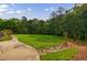 Beautifully landscaped grounds featuring a winding sidewalk and decorative rock bed at 27306 Plantation Ne Dr, Atlanta, GA 30324