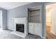 Cozy living room with fireplace and built in shelving near an open doorway and grey walls at 27306 Plantation Ne Dr, Atlanta, GA 30324