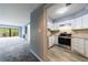 Cozy living room open to a modern kitchen with stainless steel appliances and granite countertops at 27306 Plantation Ne Dr, Atlanta, GA 30324