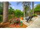 Peaceful pond setting with benches, a potted plant, and landscaping at 27306 Plantation Ne Dr, Atlanta, GA 30324
