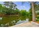 Scenic view of a pond reflecting the surrounding lush greenery and architecture at 27306 Plantation Ne Dr, Atlanta, GA 30324