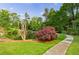 Picturesque view of a pond surrounded by mature trees and lush greenery at 27306 Plantation Ne Dr, Atlanta, GA 30324