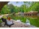 Beautiful pond view with a bench, landscaping, and reflection of trees at 27306 Plantation Ne Dr, Atlanta, GA 30324