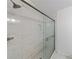 Modern bathroom shower with sleek glass doors and white tile at 27306 Plantation Ne Dr, Atlanta, GA 30324