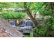 Scenic waterfall with lush greenery and gazebo creates a tranquil outdoor community space at 27306 Plantation Ne Dr, Atlanta, GA 30324