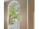 Grand arched window with decorative chandelier provides natural light and focal point at 27306 Plantation Ne Dr, Atlanta, GA 30324