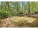 Manicured backyard with stone accents offers a private outdoor oasis surrounded by mature trees at 2975 Coles Way, Atlanta, GA 30350