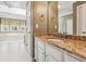 Bathroom with dual sinks, granite counters and white vanity at 2975 Coles Way, Atlanta, GA 30350
