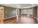 Large bedroom with tray ceilings, hardwood floors, and expansive windows with neighborhood views at 2975 Coles Way, Atlanta, GA 30350