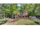 Beautiful red brick home with mature trees and landscaping nestled among green trees at 2975 Coles Way, Atlanta, GA 30350