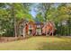 Beautiful two-story brick home with a manicured lawn and mature trees providing privacy at 2975 Coles Way, Atlanta, GA 30350