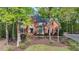 Beautiful two-story brick home with a manicured lawn and mature trees providing privacy and shade at 2975 Coles Way, Atlanta, GA 30350