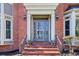 Inviting front entrance with brick steps, columns, and a glass-paneled door, framed by exterior lanterns at 2975 Coles Way, Atlanta, GA 30350