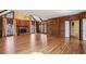 Large living room with fireplace, paneled walls, hardwood floors and an adjacent staircase at 2975 Coles Way, Atlanta, GA 30350