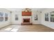 Bright living room with a brick fireplace, ceiling fan, and multiple windows at 2975 Coles Way, Atlanta, GA 30350