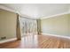 Sunlit living room featuring hardwood floors, crown molding, and a bay window at 2975 Coles Way, Atlanta, GA 30350