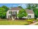 Charming two-story home with a well-manicured lawn and classic architectural details surrounded by mature trees at 3920 Cash Lndg, Marietta, GA 30066