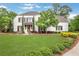 Charming two-story home featuring a well-manicured lawn, tasteful landscaping, and traditional white siding with dark shutters at 3920 Cash Lndg, Marietta, GA 30066