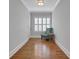 Inviting hallway with hardwood floors, plantation shutters, and cozy accent chair near window at 3920 Cash Lndg, Marietta, GA 30066