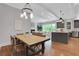 Inviting open floor plan with a dining area, living room with fireplace, and modern kitchen featuring gray cabinets at 3920 Cash Lndg, Marietta, GA 30066
