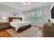 Comfortable main bedroom features a tufted headboard, matching nightstands, and natural light at 3920 Cash Lndg, Marietta, GA 30066