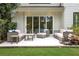 Outdoor patio with a seating arrangement, wooden table, and sliding glass doors at 3920 Cash Lndg, Marietta, GA 30066