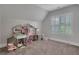 Spacious playroom with plush carpeting, plantation shutters, and a charming dollhouse at 3920 Cash Lndg, Marietta, GA 30066