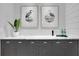 Stylish wet bar features elegant gray cabinetry, marble countertop, designer hardware, and decorative botanical prints at 3920 Cash Lndg, Marietta, GA 30066