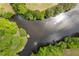 Breathtaking aerial view of the property's lake, lush greenery, and serene waters at 109 Hawks Bnd, Canton, GA 30115