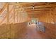 Partially finished attic space with exposed beams, wood flooring, and natural light from a window at 109 Hawks Bnd, Canton, GA 30115