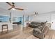Wide-open basement area showcasing a comfortable leather couch, pool table, and bar area for entertaining at 109 Hawks Bnd, Canton, GA 30115